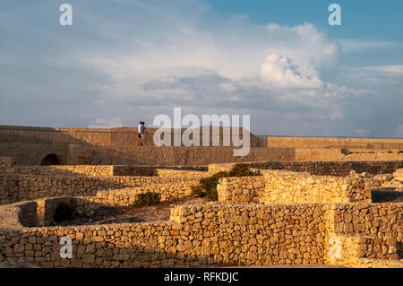 Zwei junge Männer zu Fuß entlang der nördlichen Stadtmauer der Zitadelle in Victoria, Gozo, Malta. Stockfoto