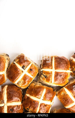 Einem hohen Winkel Blick auf Ostern Hot Cross Buns mit klebrigen süßen Glasur auf einem isolierten weißen Hintergrund mit Kopie Raum Stockfoto