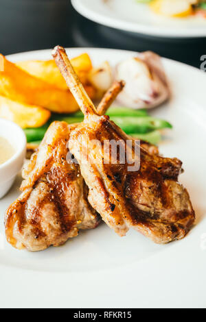 Gegrilltes Lamm Fleisch Steaks mit Gemüse und Pommes frites in weiße Platte Stockfoto