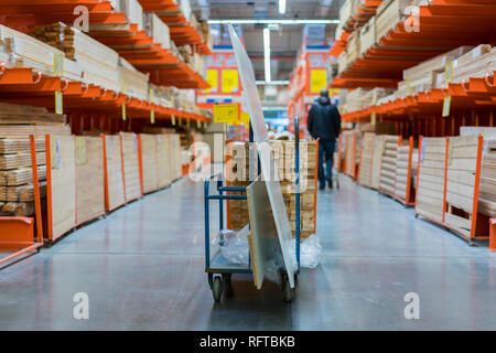 Bau Warenkorb im Gebäude zu speichern. Karren mit Boards geladen. shop von Baustoffen. Regale mit Platten, Holz und Baumaterial. geladen. c Stockfoto