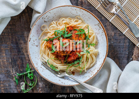 Spaghetti mit Thunfisch Kugeln in pikanter Tomatensauce und Rakete Stockfoto