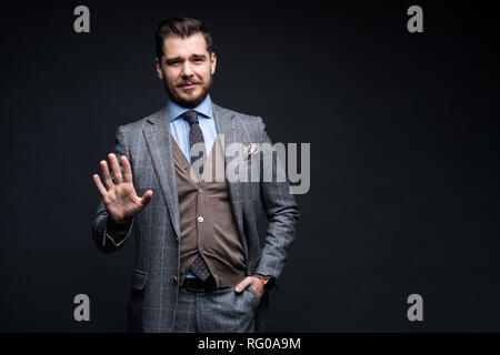 Portrait von Angeregten zufrieden Fröhlich zuversichtlich positive stattlichen demonstrieren Daumen hoch nach oben isoliert auf schwarzen Hintergrund. Stockfoto