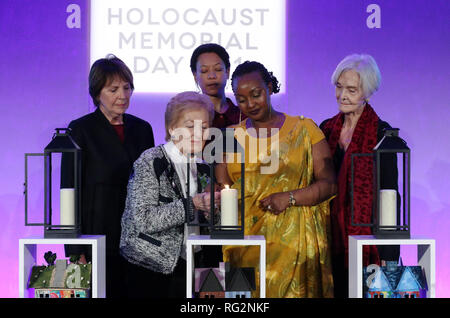 Akteure (hintere Reihe von links nach rechts) Dame Penelope Wilton, Nina Sosanya und Sheila Hancock melden Sie Holocaust Survivor Mindú-Hornick (vorne links) und Völkermord in Ruanda survivor Chantal Uwamahoro (vorne rechts) in eine Kerze im Gedenken an alle Opfer von Völkermord an den Holocaust Memorial Day Zeremonie die QEII Zentrum, Westminster, London. Stockfoto