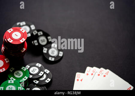 Casino Chips und Karten auf minimalistische schwarzen Hintergrund. Casino Spiel. Online Casino. Glücksspiel Konzept, Poker mobile App. Poker spiel Thema. Ro Stockfoto