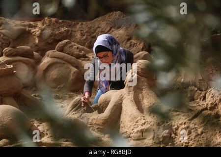 (190128) - GAZA, Jan. 28, 2019 (Xinhua) - Sand Artist Rana Ramlawi arbeitet auf ihrem Sand Skulpturen in Gaza Stadt, Jan. 24, 2019. Rana Ramlawi, ein 23 Jahre alter palästinensischer Junge Frau aus dem Gazastreifen, Erholungsorte auf Sand Kunst die Sache der Palästinenser und die israelisch-palästinensischen Konflikt zu markieren. In ihren Skulpturen aus Sand und Wasser hergestellt, viele Meldungen in Unterstützung der palästinensischen Sache vermittelt, da sie glaubt, dass Kunst ist ein wichtiger Weg, um die Rechte und die Forderung nach Freiheit zu betonen und die Beendigung der israelischen Besatzung. "Eines meiner Ziele in meinen Arbeiten ist dieses Erbe zu bewahren und zu sagen Stockfoto