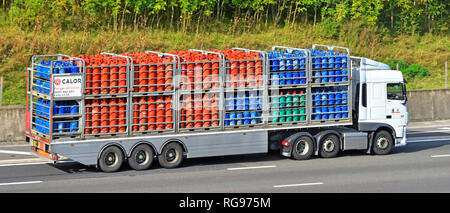 Seitenansicht der Lieferkette der Marke Calor Gas: Lkw und Gelenkanhänger mit Flaschen-Butan- und Propangasflaschen auf der britischen Autobahn Stockfoto