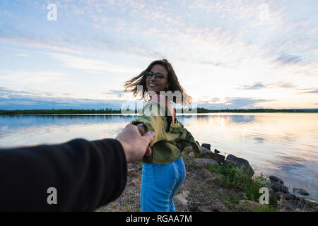 Finnland, Lappland, die glückliche junge Frau mit Mann am See bei Dämmerung Stockfoto