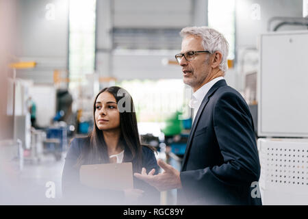 Geschäftsmann eine Frau in High Tech Unternehmen, ein Treffen in der Werkhalle Stockfoto