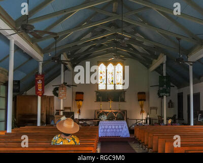 LAHAINA, VEREINIGTE STAATEN VON AMERIKA - 7. JANUAR 2015: ein Anbeter sitzt in einer Kirchenbank im Inneren der Unschuldigen Kinder Kirche in Lahaina, Maui Stockfoto