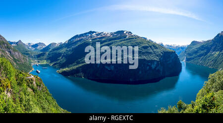 Eine Aussicht auf einen grünen, tiefen Fjord von Bergen unter einem blauen Himmel umgeben. Norwegen, Ørnesvingen - Adler Straße Stockfoto