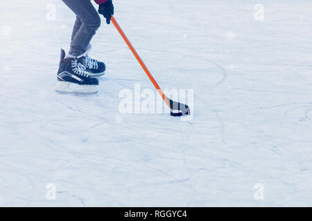 Person spielen Eishockey auf gefrorenen Nymphenburger Kanal, München, Deutschland Stockfoto