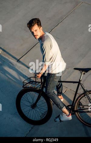 Junger Mann mit Pendler fixie Bike auf Betonplatten Stockfoto