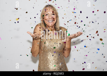 Ältere Frau mit goldenen Kleid, celebtraing Silvester Stockfoto