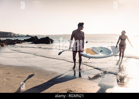 Frankreich, Bretagne, junges Paar Durchführung einer SUP Boards am Meer zusammen Stockfoto