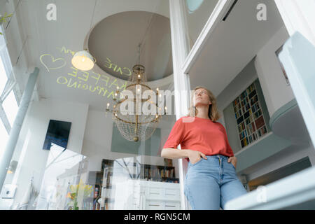 Low Angle View der jungen Frau, die in einem Cafe Stockfoto