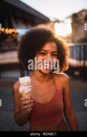 USA, Nevada, Las Vegas, Porträt der glückliche junge Frau Eis essen in der Stadt Stockfoto