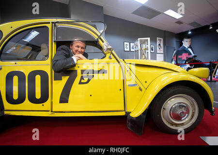 Bochum, Deutschland. 31 Jan, 2019. Der Filmjournalist und Sammler Siegfried Tesche sitzt in der Ausstellung "In geheimer Mission - Der Spion, der aus Wattenscheid kam" in Gelb 'Duck' vom Typ Citroen 2CV spécial, wie es in dem James Bond Film "In tödlicher Mission". Die Ausstellung zeigt, Requisiten und berühmten Fahrzeuge des Films Agent James Bond in einem leeren Shop. Der Untertitel der Ausstellung bezieht sich auf eine fiktive Biografie nach James Bond, James Bond im Jahre 1920 in, was jetzt der Bochumer Stadtteil Wattenscheid geboren wurde. Quelle: Bernd Thissen/dpa/Alamy leben Nachrichten Stockfoto