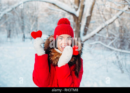 Schöne junge Frau hält ein rotes Herz in den Händen in Winter Park. Winter. Stockfoto
