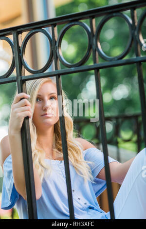 Eine attraktive blonde Haare kaukasischen High School senior posieren für ältere Bilder. Weibliche Teenager Portrait draußen im Park im Sommer. Stockfoto