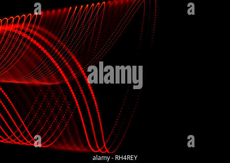 Mehrere rote gepunktete Linien mit abstrakten Formen. Licht Malerei Fotografie. Rote Flecken auf schwarzem Hintergrund. Stockfoto