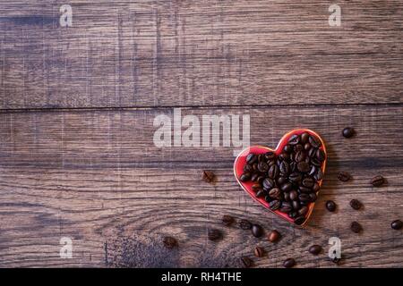 Kaffeebohnen in Herzform Teller/Valentines Tag Hintergrund Stockfoto