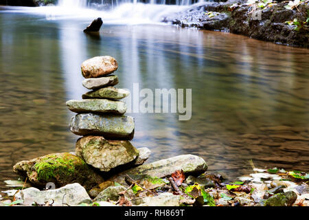 Ausgewogene Steine auf einen Wasserfall Stockfoto