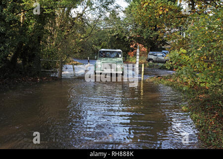 Land Rover durch die flodoed Ford über die Lin-Brook Stream in der Flut in der Nähe von Ringwood Hampshire England Großbritannien Stockfoto