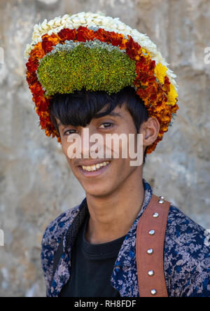 Porträt einer Blume jungen Mann mit einem floralen Krone auf dem Kopf, Provinz Jizan Addayer, Saudi-Arabien Stockfoto