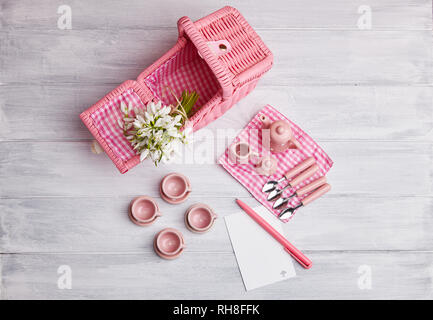 Picknick Card mit Tisch und Besteck, rosa weiß überprüft Serviette, weiß Rustikal Vorstand Hintergrund, leeren Raum für Text. Stockfoto