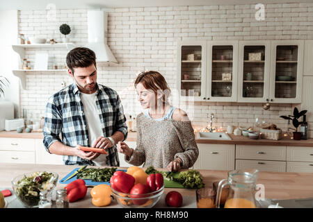 Dunkelhaarige jungen attraktiven Mann in einem kariertem Hemd verwirrt auf der Suche Stockfoto