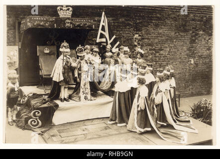 Ursprüngliche Postkarte aus der Zeit der 1930er Jahre mit der Krönung von König George VI. Und Königin Elizabeth, Schulkinder, die Kostüme nachspielen, Datum 1937 über der Bühne, Großbritannien. Stockfoto