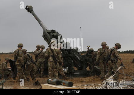 Fallschirmjäger in den zweiten Bataillon zugeordnet, 319 Airborne Field Artillery Regiment, 2nd Brigade Combat Team, 82nd Airborne Division mit einem M777 Haubitze auf Salerno Drop Zone während eines schweren drop" im Fort Bragg, North Carolina, Jan. 23, 2019. Die Funktion getestet Schwere der Brigade drop Beschäftigung für Zertifizierung und Validierung Verfahren während ihrer kombinierten Waffen Live Fire Übung (U.S. Armee Foto von SPC. Justin W. Stafford) Stockfoto