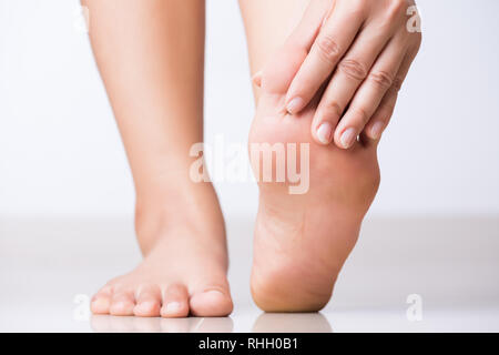 Closeup weibliche Hand Fuß Schmerzen, Gesundheitswesen Konzept. Stockfoto