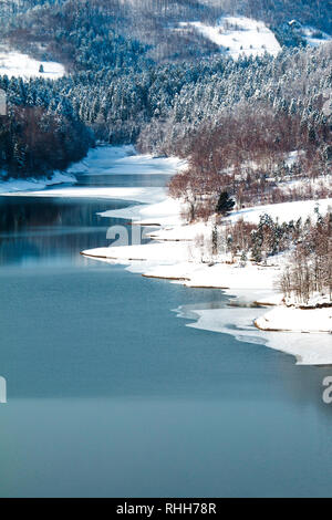 Wunderschönen kroatischen Winterlandschaft, Panorama der Lokvarsko See und Wälder unter Schnee in Gorski kotar und Risnjak Berg im Hintergrund Stockfoto