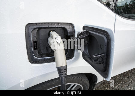 Elektrofahrzeug mit den Netzstecker mit dem Auto verbunden Stockfoto