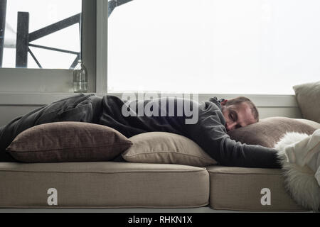 Mann schlafend auf der Couch Stockfoto