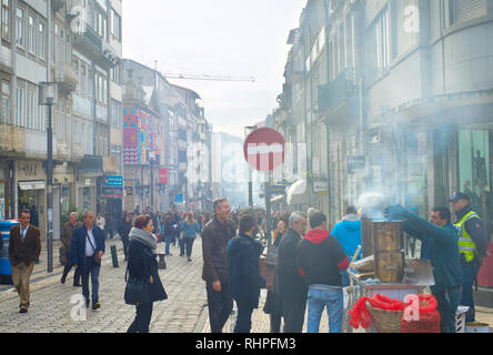 PORTO, PORTUGAL - 11 November, 2016: Lokale Verkäufer der Verkauf Kastanie auf der Straße Santa Catarina - Haupteinkaufsstraße von Porto, Portugal Stockfoto