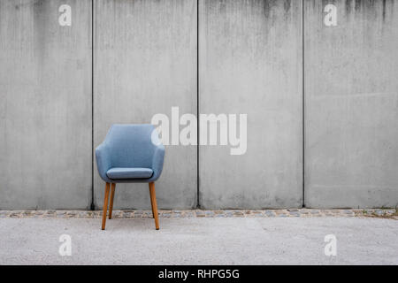 Leerer Stuhl mit Beton Wand Hintergrund auf bürgersteig - Stockfoto