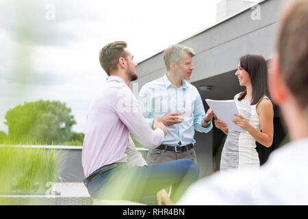 Lächelnd Geschäftsfrau diskutieren über Dokumente mit Kollegen im Büro Terrasse Stockfoto