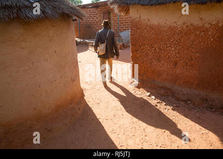 Bodadiougou Dorf, Banfora, Cascades Region, Burkina Faso, 4. Dezember 2016; Godima Siri, ein Bauer und Chef seines Haushalts, geht auf seine Verbindung zurück, um seinen Haushalt zu organisieren. Stockfoto