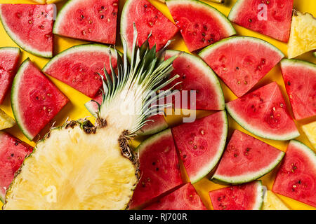 Sommer Konzept. Konzeptionell. Lecker appetitlichen Scheibe Ananas mit Wassermelone auf Gelb hell leuchtenden Hintergrund mit Holz Buchstaben Sommer. Stockfoto