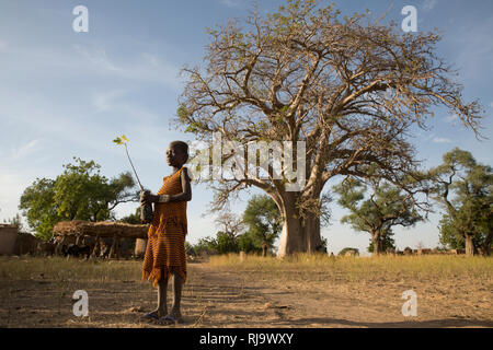 Baribsi Village, Yako, Burkina Faso, 30. November 2016; Diane Kientega, 8, mit einem Boabab, der vor dem Dorf Baobab-Baum sackt. Stockfoto