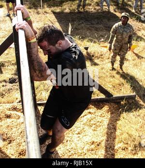 Armee Sgt. 1. Klasse Michele S. Bell, 143 Sustainment Command (Auslandseinsätze), Prost auf einen Konkurrenten klettern die Berliner Mauer Hindernis während der harten Mudder Endurance Challenge Nov. 5, 2016, in Palm Bay, Fla. Bell, ein Eingeborener von Trinidad, ist seit mehr als 20 Soldaten der 143. sustainment Command (Auslandseinsätze), die moralische Unterstützung für dieses internationale sportliche Extravaganz, die aus einer 10-12 Meile Kurs mit fast zwei Dutzend Hindernisse, Tests individuelle Kraft und Ausdauer durch Teambildung und Zusammenarbeit in einer Gruppe. Seit 2012 ist die Armee finden hat partnered Stockfoto
