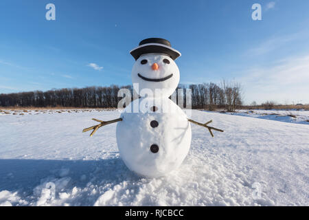 Lustige Schneemann in schwarzen Hut auf schneebedeckten Feld. Weihnachten und neues Jahr Hintergrund Stockfoto