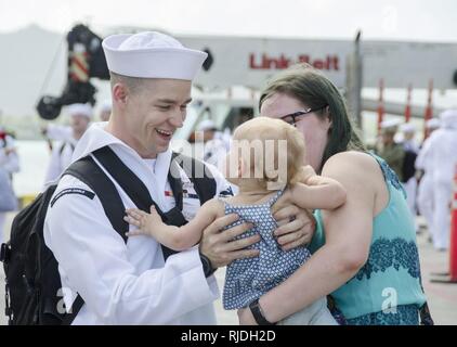 POLARIS, Guam (23.01.2018) ein Matrose zum u-boot Tender USS Frank Kabel zugewiesen (40), vereint mit seiner Familie während seiner Heimkehr zu Apra Harbor, Guam, 31.01.23. Frank Kabel ging Guam März 7, 2017, Unterstützung der maritimen expeditionary Operations in der dritten Flotte Fläche von Operationen und machte einen trockendock Wartung Verfügbarkeit am Vigor Industrial Werft in Portland, Erz Frank Kabel eingeführt, nach Guam, Reparaturen, rearm und reprovisions eingesetzt waren, U.S. Naval Forces im Indo-pazifischen Region. Stockfoto