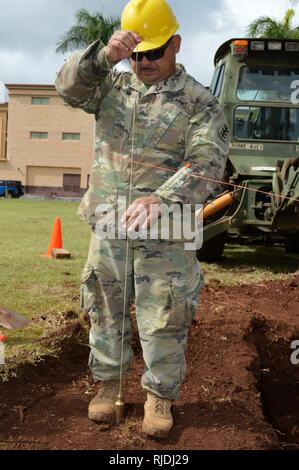 Sgt. Jose Garcia, eine Tischlerei und Mauerwerk Spezialist für die 561St Ingenieur Gesellschaft zugeordnet, 84th Engineer Battalion, 130 Engineer Brigade, 8 Theater Sustainment Command, verwendet ein Lot oder sinken, die Ebene, auf Schofield Baracke, Hawaii, am Jan. 23, 2018 zu prüfen. Die Ingenieure arbeiten, den Boden zu bereiten, damit der 25 Infanterie Division 3. Brigade Combat Team Bronco Memorial in der Nähe platziert werden können. Stockfoto