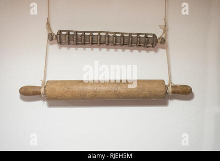 Zwei alte Holz- rolling Pins an der Wand hängen: Die Weiche für den Teig die andere Form für Ravioli Stockfoto