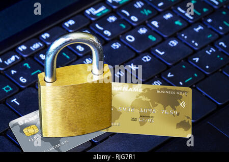 Goldene Vorhängeschloss auf fiktiven Kreditkarten auf der Computertastatur. Konzept der Internet Security, Datenschutz, Computerkriminalität Verhinderung für online Sh Stockfoto