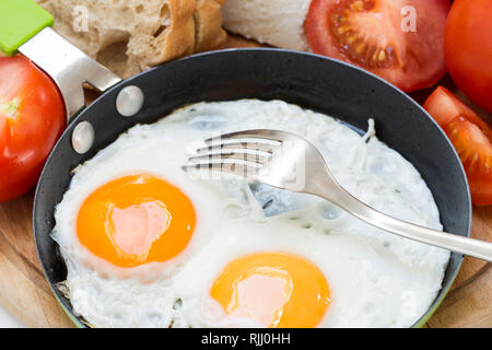 Spiegeleier mit Käse, Brot und Tomaten Stockfoto