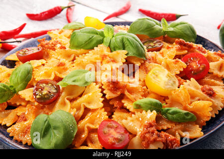 Farfalle. Köstliche cremige Italienische Penne Pasta Starter mit Pfeffer würzen und frischem Basilikum von oben gesehen auf rustikalen. Stockfoto